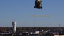 Hoist being lifted by Crane Brainerd historic water tower