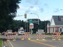 Intersection with road closed sign and stoplight off